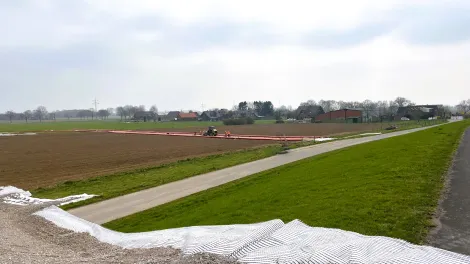 Blick auf die Baustelle der Gleichstromtrasse A Nord inmitten von Feldern. 